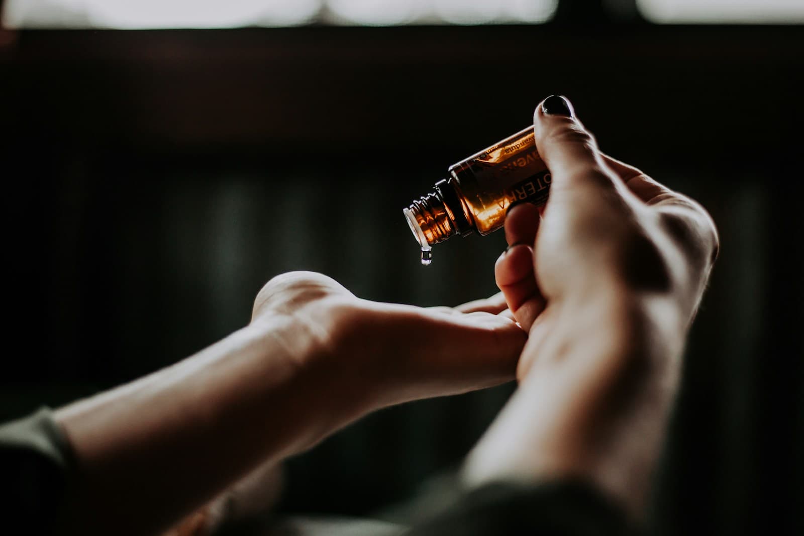 Serum dropper bottle held over an open hand